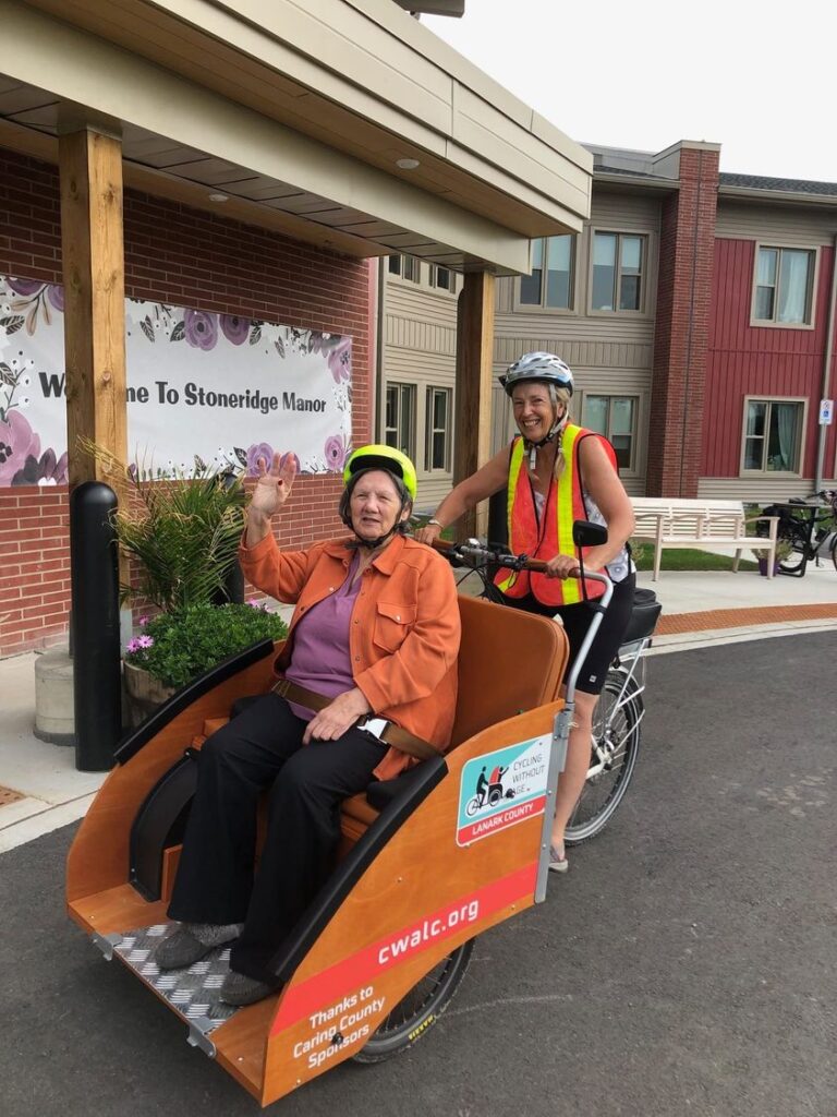 Pilot Catherine Cosstick is shown driving a passenger in the CWALC trishaw.