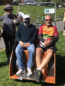 Treff Peters and Mark Manzon seated in the Trishaw.